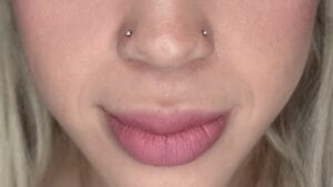 double nostril piercing with silver jewelry on woman's lower face