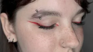 eyebrow, nose, and ear piercings on closed eyes girl