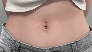 navel piercing on a flat belly with barbell jewelry