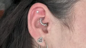 Flat, rook, and lobe piercings with different styles of jewelry