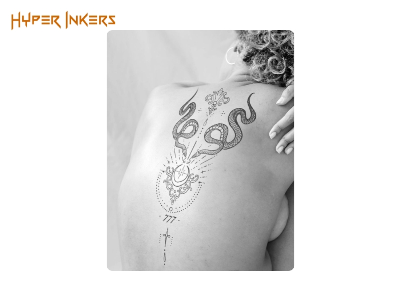 best places for a back tattoo - Hyper Inkers A powerful ornamental piece featuring symmetrical snakes and symbols of guidance, creating a deeply personal and mystical statement.